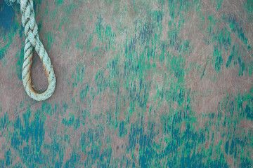 Marine background old wooden plank with green and blue paint remnants and a dew shaped as a loop
