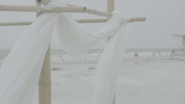White fabric curtains blowing in wind on beach