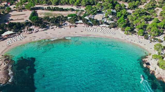 Scenic Aerial view of Cala Bassa Beach Club and resort on Ibiza Island, Spain. Beautiful vacation location with mediterranean sea on the Balearic Islands.