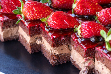 Strawberry tartlet. Small cake with strawberries fresh out of the oven in a tray. close up