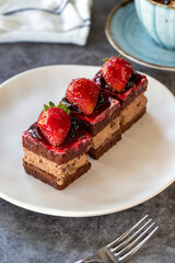 Strawberry tartlet. Small strawberry cake in a plate. On dark floor. close up