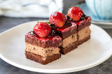 Strawberry tartlet. Small strawberry cake in a plate. On dark floor. close up