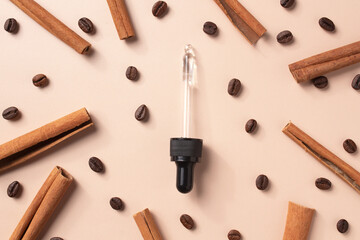 Dropper with serum. Coffee beans and cinnamon sticks. Hyaluronic acid oil, serum with collagen and peptides skin care product.