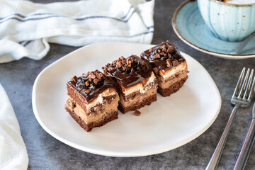 Chocolate tartlet. Small chocolate cake in a plate. On dark floor. close up