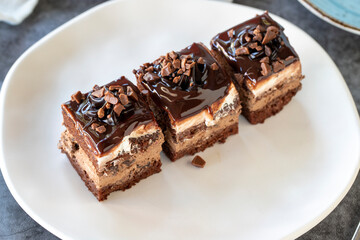 Chocolate tartlet. Small chocolate cake in a plate. On dark floor. close up