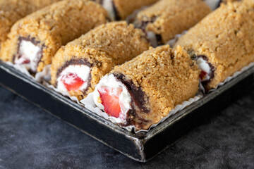 Strawberry and chocolate tartlet. Freshly baked strawberry shortcake in a tray. close up