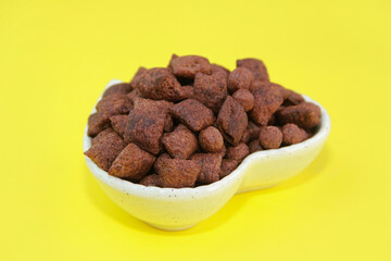 children's dry chocolate breakfast pillows and balls in a ceramic plate