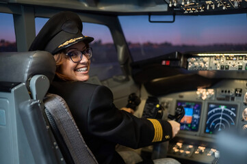 Female pilot on board the aircraft. Caucasian woman in flight simulator. © Михаил Решетников
