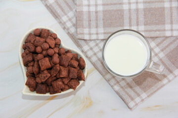 children's dry chocolate breakfast in a plate and a glass of milk