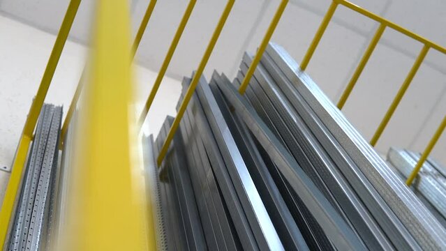 Aluminium stack of profiles in a warehouse. Metal industrial products, manufacturing for building and construction business production. Low dutch angle shot