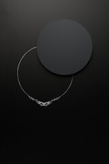 Silver necklace on black background. Uniqe shadow effect