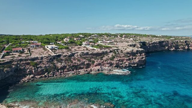 A beautiful cave beach on Formentera Island by Ibiza, Balearic Islands, Spain. Cala en Baster - relaxing beach with blue and turquoise mediterranean sea water.