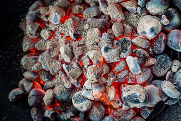 Empty grill with red-hot briquettes, close-up.