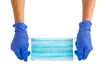 Hand holds a medical face mask against viruses and bacteria