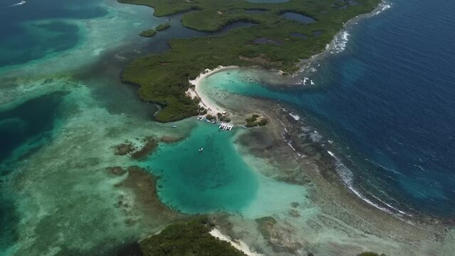 Aerial shot of Boca Seca Key, located in Morrocoy National Park in Venezuela, surrounded by crystal clear waters and coral reefs.