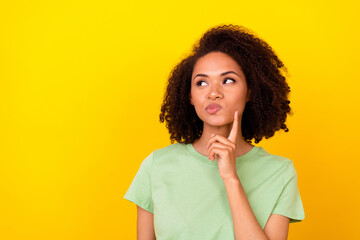Photo of unsure brunette millennial lady finger face look promo wear green t-shirt isolated on...