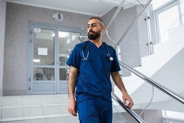 Professional surgeon on the stairs of the clinic.