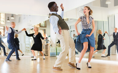 Woman with african man practising charleston dancing