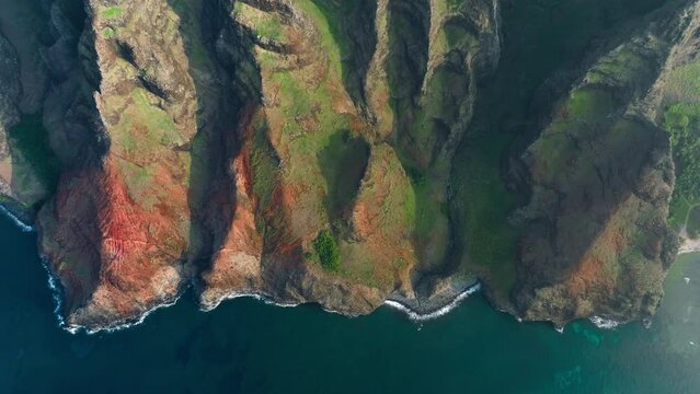 Kauai island, Hawaii USA travel background. Aerial view of Kauai beautiful Napali Coast National park. Cinematic shot of breathtaking magnificent green mountain ridges in golden sunset light 4K summer