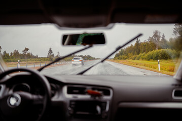 Fototapeta na wymiar Driving car in bad weather conditions. Heavy rain.