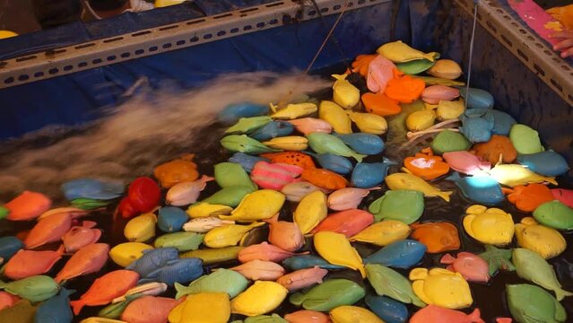 Child Fisher Catching Plastic Toy Fish On Pool Amusement Park. Little Kids Have Fun On Fishing Carnival Festival Entertainment
