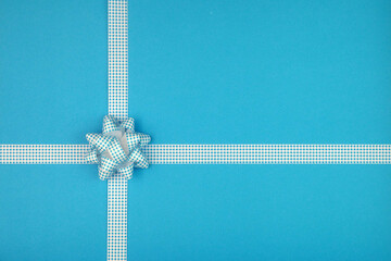 Blue bow and ribbon crossed to decorate gifts