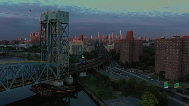 Cinematic dawn blue hour slow long pan from train going over the Park Ave Bridge through to Harlem public housing project
