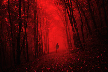 man in dark scary forest on halloween night