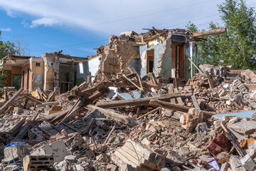 An abandoned house collapses. The house is destroyed. Cracks in wall of house. Destruction of old...