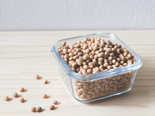soy beans in square glass  bowl on wooden table.