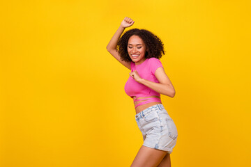 Fototapeta Photo of hooray brunette young lady dance wear pink t-shirt shorts isolated on vivid orange color background obraz