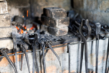 Fototapeta Vintage tools in an old forge, workshop of a rustic craftsman. obraz