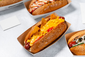 Fast food hot dog banner on a light grey stone textured background, hotdog menu template, hotdog menu mock up, free space for text, different hot dog types