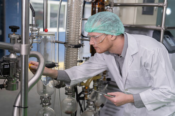 In the cannabis plantation plant engineer routine check the distillation glass syphon tube...