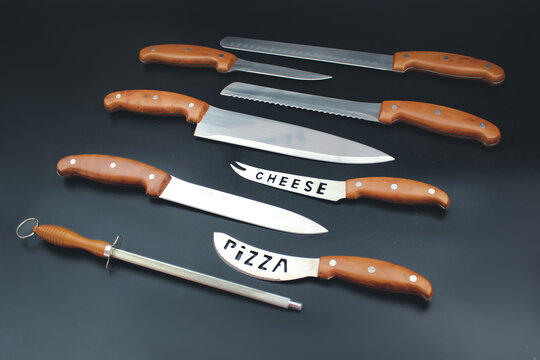 Kitchen knifes inventory on black backgroun in a row.