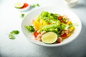Fresh green salad with shrimps and mango