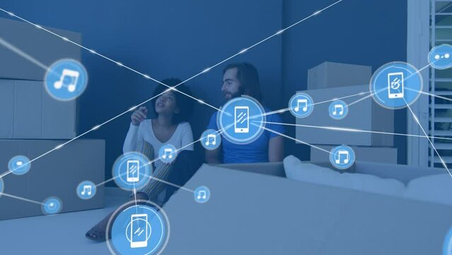 Animation of network of connections with icons over diverse couple moving house