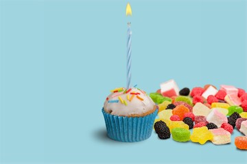 Celebration birthday cupcake on color background
