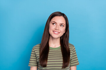 Fototapeta premium Photo of impressed young brunette lady look up wear green t-shirt isolated on blue color background