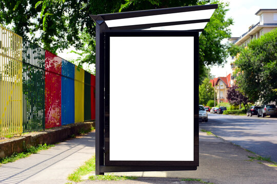 bus shelter at bus stop. white poster and commercial ad space display lightbox. base for mockup. composite image. blank ad panel. glass design. urban park setting. green background