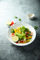 Fresh green salad with shrimps and mango