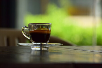 Coffee is a cup of coffee placed on the floor.