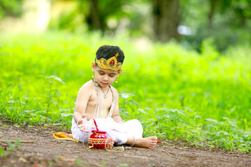 happy Janmashtami Greeting Card showing Little Indian boy posing as Shri Krishna or kanha or...
