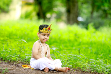 happy Janmashtami Greeting Card showing Little Indian boy posing as Shri krishna or kanha/kanhaiya...