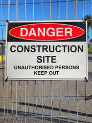 Construction site health and safety message rules signage on fence boundary - unauthorised persons keep out.