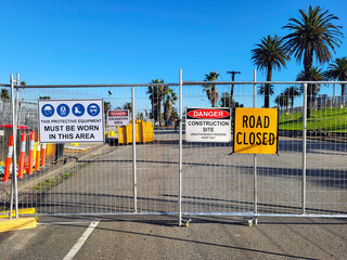 Construction site health and safety message rules signage on fence boundary - unauthorised persons...