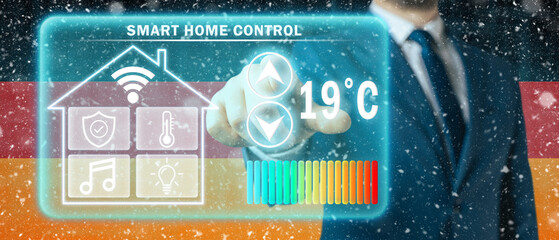 Frozen citizen of Germany adjusting heating temperature on a virtual screen of smart home controller, winter blizzard background. Concept of forced thrift because increased price for heating home