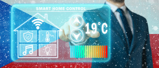 Frozen citizen of Czech Republic adjusting heating temperature on virtual screen of smart home...