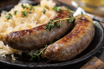 Bratwurst dinner with sauerkraut garnished with thyme