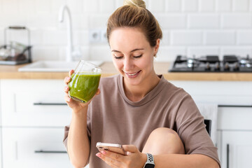 Healthy lifestyle, diet eating, weight loss concept. Young woman drinking fresh green smoothie...